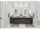 Bright and airy bathroom with double vanity, elegant LED mirrors, and contemporary fixtures at 621 Estates Pl, Longwood, FL 32779