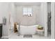 Elegant bathroom featuring a soaking tub, tile accent wall, and modern fixtures at 621 Estates Pl, Longwood, FL 32779