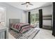 Cozy bedroom with a neutral color scheme, a patterned rug, and natural light from the window at 621 Estates Pl, Longwood, FL 32779