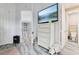 A cozy bedroom showcases a white dresser with a mounted TV and convenient access to an adjacent bathroom at 621 Estates Pl, Longwood, FL 32779