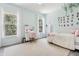 Bright bedroom featuring light blue walls, two large windows, a cozy bed, and a desk area at 621 Estates Pl, Longwood, FL 32779