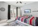 Relaxing bedroom with a ceiling fan, access to an outdoor patio, and a TV at 621 Estates Pl, Longwood, FL 32779
