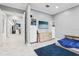 A stylish bedroom features white marble floors, a modern entertainment center, and a comfortable bed with blue accents at 621 Estates Pl, Longwood, FL 32779