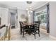 Bright dining room featuring an elegant chandelier, sleek marble floors, and views of the outdoor spiral staircase at 621 Estates Pl, Longwood, FL 32779