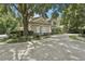 Stately home featuring a circular driveway and meticulously maintained landscaping at 621 Estates Pl, Longwood, FL 32779