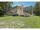 View of backyard, screened enclosure, and balcony at 621 Estates Pl, Longwood, FL 32779