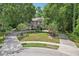 Elegant home featuring a circular driveway and mature trees providing ample shade at 621 Estates Pl, Longwood, FL 32779