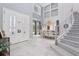 Grand foyer featuring soaring ceilings, staircase, and elegant decor at 621 Estates Pl, Longwood, FL 32779