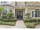 Inviting front entrance showcasing a beautiful double door and manicured landscaping at 621 Estates Pl, Longwood, FL 32779