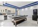 An entertainment room has a stylish wet bar and a ping pong table for entertainment and a sleek design at 621 Estates Pl, Longwood, FL 32779