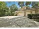 Three-car garage with a large driveway and manicured shrubbery at 621 Estates Pl, Longwood, FL 32779