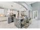 Open concept kitchen with gray and white cabinetry, a granite island with seating, and modern lighting at 621 Estates Pl, Longwood, FL 32779