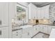 Kitchen features a farmhouse sink, white cabinets, granite countertops, and modern appliances at 621 Estates Pl, Longwood, FL 32779