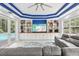 Inviting living room has built-in shelving, a large TV, and access to the pool area, perfect for indoor-outdoor living at 621 Estates Pl, Longwood, FL 32779