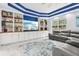 A well-appointed living room with custom shelving, a large TV, and comfortable seating overlooks the backyard at 621 Estates Pl, Longwood, FL 32779