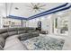 Bright living room with a large sectional sofa, a built-in bar area, and access to the backyard patio at 621 Estates Pl, Longwood, FL 32779