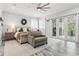 Spacious main bedroom suite with a sitting area, ceiling fan, and private balcony access at 621 Estates Pl, Longwood, FL 32779
