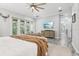 Comfortable main bedroom featuring a ceiling fan, mounted TV, and a sliding glass door to the outside at 621 Estates Pl, Longwood, FL 32779
