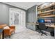 Spacious home office featuring a built-in desk and shelving unit, with a view into the hallway at 621 Estates Pl, Longwood, FL 32779