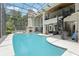 Large, screened in pool area with fireplace and spiral staircase at 621 Estates Pl, Longwood, FL 32779