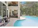 Stunning pool area with multiple seating areas, a spiral staircase, and a screened enclosure at 621 Estates Pl, Longwood, FL 32779