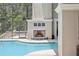 Inviting pool area with a tiled fireplace and a screened enclosure for year-round enjoyment at 621 Estates Pl, Longwood, FL 32779