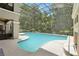 Gorgeous in-ground pool inside screened enclosure with surrounding trees at 621 Estates Pl, Longwood, FL 32779