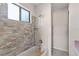 Bathroom featuring tiled shower, tub and a window that brings in natural light at 628 Olympic Dr # 8-C, Ocoee, FL 34761
