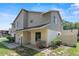 Two-story home with beige siding and a well-maintained lawn with shrubbery at 628 Olympic Dr # 8-C, Ocoee, FL 34761
