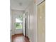 Hallway with an open door showcasing a view of the outdoors and wood-look laminate floors at 628 Olympic Dr # 8-C, Ocoee, FL 34761