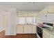 Bright kitchen featuring an oven, microwave, and an open layout at 628 Olympic Dr # 8-C, Ocoee, FL 34761