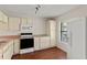 Bright kitchen featuring an oven, microwave, and window with outside view at 628 Olympic Dr # 8-C, Ocoee, FL 34761