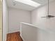 Landing with closet and ceiling fan with a skylight, and a wooden floor at 628 Olympic Dr # 8-C, Ocoee, FL 34761