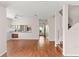 Open-concept living space with wood-look flooring and easy access to the hall and kitchen at 628 Olympic Dr # 8-C, Ocoee, FL 34761