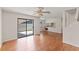 Living room with laminate floors, ceiling fan, and sliding glass door to outdoor space at 628 Olympic Dr # 8-C, Ocoee, FL 34761