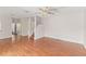 Spacious living area with wood-look laminate floors, ceiling fan and open access to front door at 628 Olympic Dr # 8-C, Ocoee, FL 34761