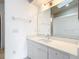 Bright bathroom featuring a modern vanity with an oversized mirror and tiled walls at 709 Orchid Dr, Davenport, FL 33897