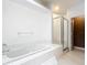A large tiled bathtub with an adjacent standing shower at 709 Orchid Dr, Davenport, FL 33897