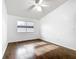 Well-lit bedroom featuring wood floors, ceiling fan, and a window allowing natural light at 709 Orchid Dr, Davenport, FL 33897