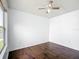 Cozy bedroom with dark hardwood floors, ceiling fan and natural light from the window at 709 Orchid Dr, Davenport, FL 33897