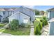 Charming townhome featuring a blue exterior, well-maintained landscaping, and a welcoming walkway at 709 Orchid Dr, Davenport, FL 33897