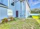 Charming townhome featuring a blue exterior, well-maintained landscaping, and a welcoming walkway at 709 Orchid Dr, Davenport, FL 33897