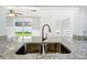 Modern kitchen featuring stainless steel appliances, white cabinetry, and granite countertops at 709 Orchid Dr, Davenport, FL 33897
