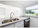 Modern kitchen featuring stainless steel appliances, white cabinetry, and granite countertops at 709 Orchid Dr, Davenport, FL 33897
