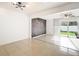 Bright living room with a brick accent wall, tiled floors and sliding glass doors to the outside at 709 Orchid Dr, Davenport, FL 33897