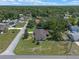Wide aerial view of a home with a large yard, surrounded by mature trees in a quiet residential neighborhood at 73 Alano Rd, Debary, FL 32713