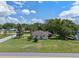 Aerial view of a well-maintained home with a spacious yard, mature trees, and a quiet neighborhood setting at 73 Alano Rd, Debary, FL 32713