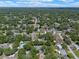 Wide aerial perspective of the community surrounded by lush greenery and clear blue skies at 73 Alano Rd, Debary, FL 32713