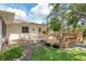 Charming backyard featuring a multi-level deck, lush lawn, and mature trees creating a serene outdoor living space at 73 Alano Rd, Debary, FL 32713