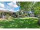 Expansive backyard with a deck, green grass, and shed at 73 Alano Rd, Debary, FL 32713